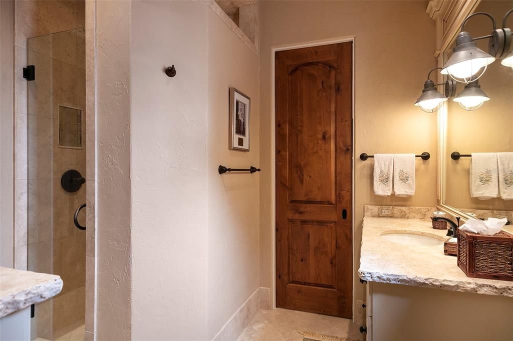 Bedroom suite #3 offers an en-suite bath with walk-in shower and custom vanity.