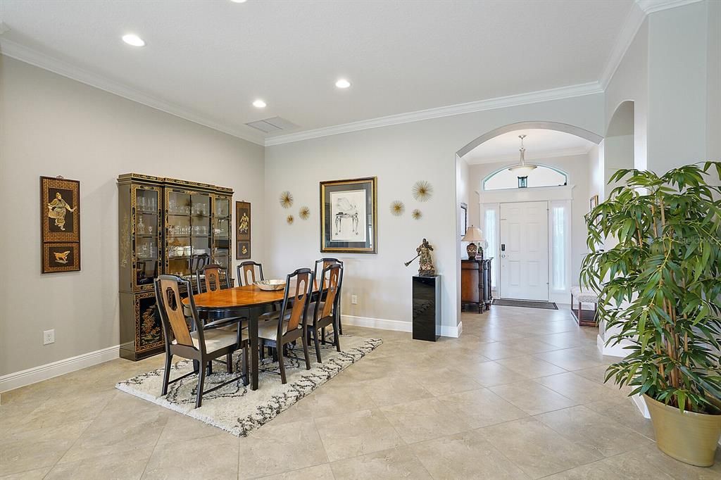 Dining area with crown molding and tile floor