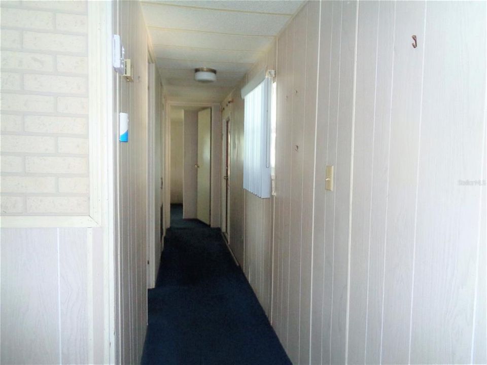 Carport Door Down the Hall to the Right