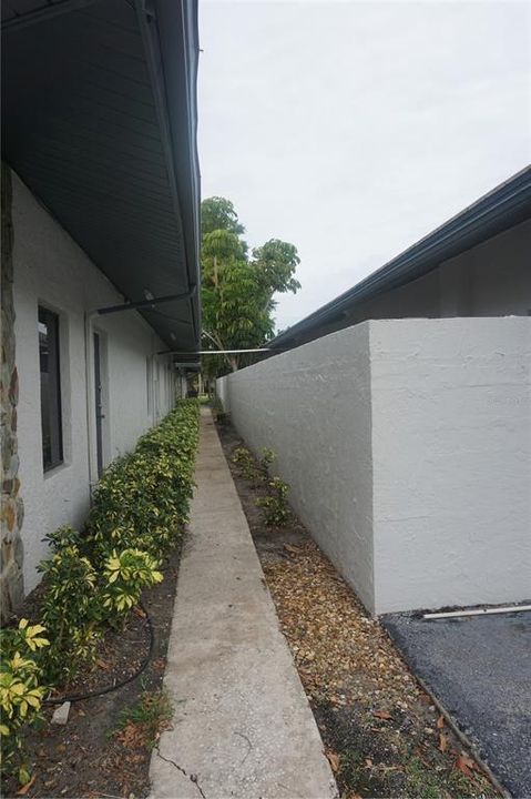 Walkway on the backside of building with rear entranc