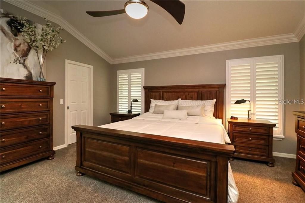 Master bedroom with vaulted ceiling & plantation shutters