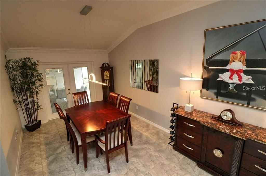 Dining area with vaulted ceiling and crown molding