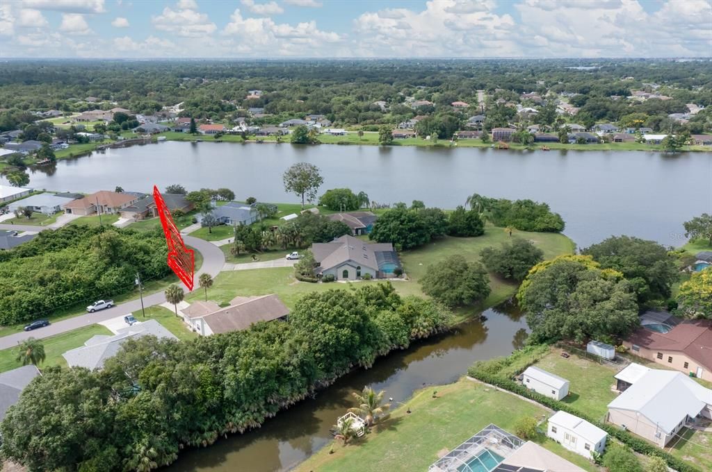 Located on Fresh Water Canal with access to large lake. 2 large oak trees exist within foliage, can be easily cleared out - no protected foliage exists per landscape quote received.