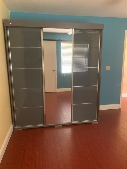 Custom grey mirrored closet for hanging and folding clothes. Plenty of storage here for all of your needs!