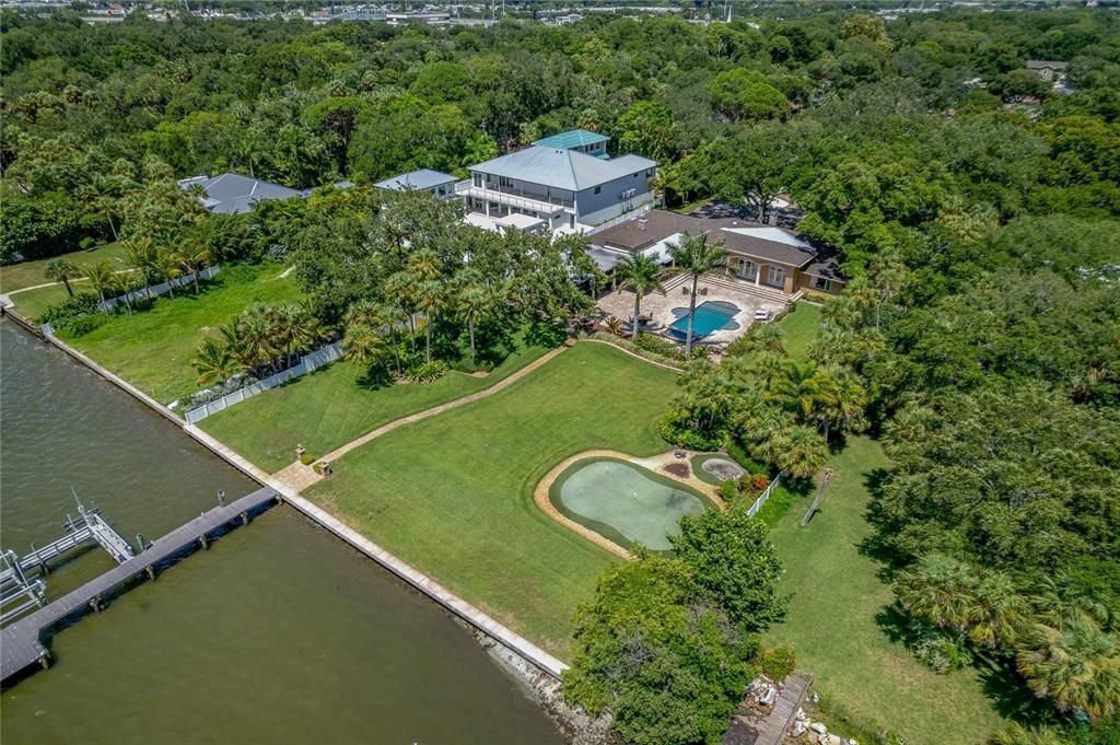 Exquisite waterfront estate in the heart of St Petersburg located on a 1.75 acre lot with 150 ft of waterfront, putting green, gaming pool. a location for a 60ft RV AND room to entertain hundreds of friends in the outdoor entertaining areas!