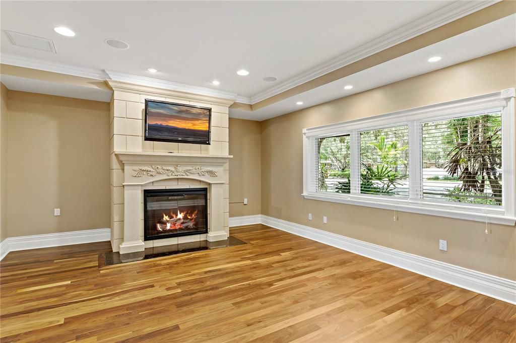 Inviting den with electric fireplace, hardwood flooring and surround sound.