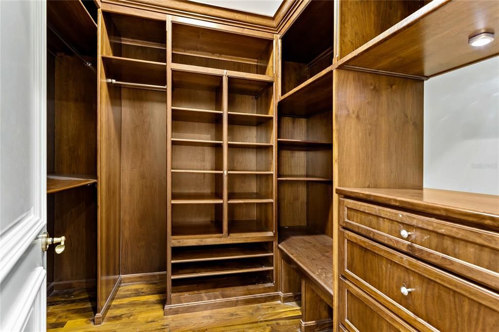 2nd spacious walk in closet with custom cabinetry.