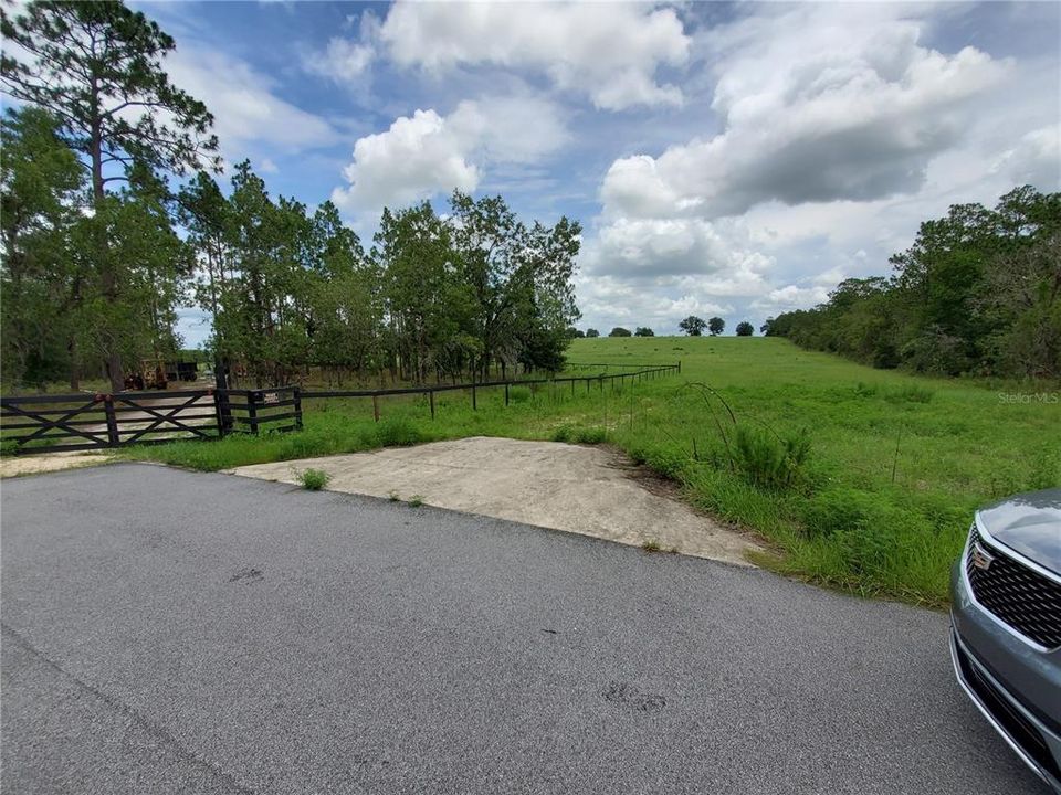 cement drive to lot next to the 3 acres and large pasture ( farm ) to the east of the listing