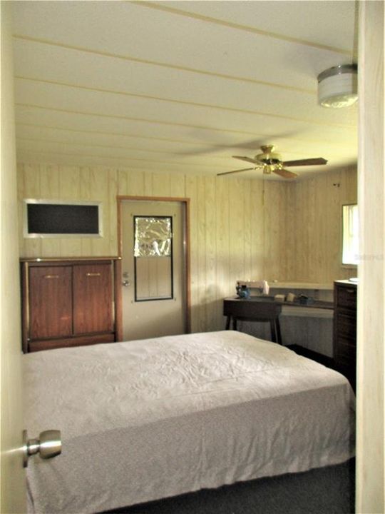 Master bedroom with door to back porch