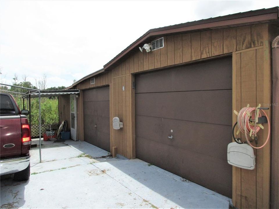 First door is a deep garage with side door entrance, 2nd is 1/2 garage with electric,  Entry door is to Apartment.