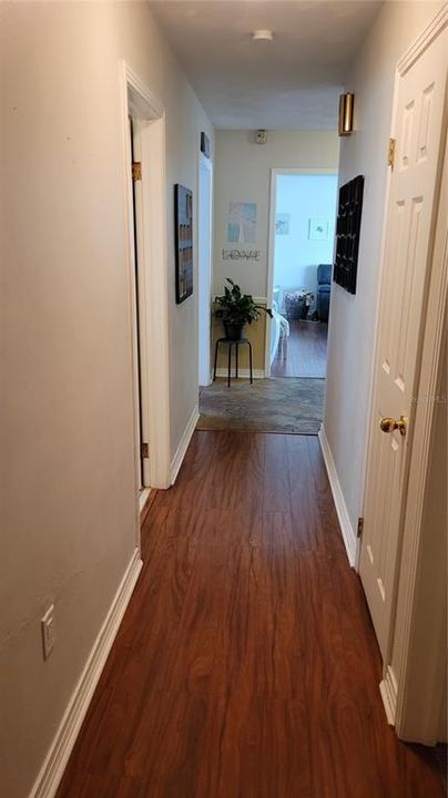 Hallway with linen closet from bedrooms facing foyer.