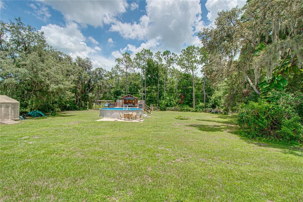 Large .91 acre yard with above ground pool and deck