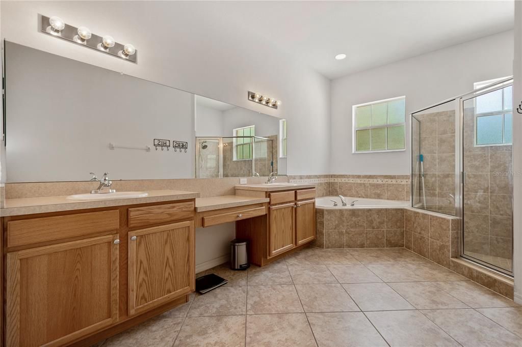 Owner's ensuite with double sink vanity, garden tub and walk in shower