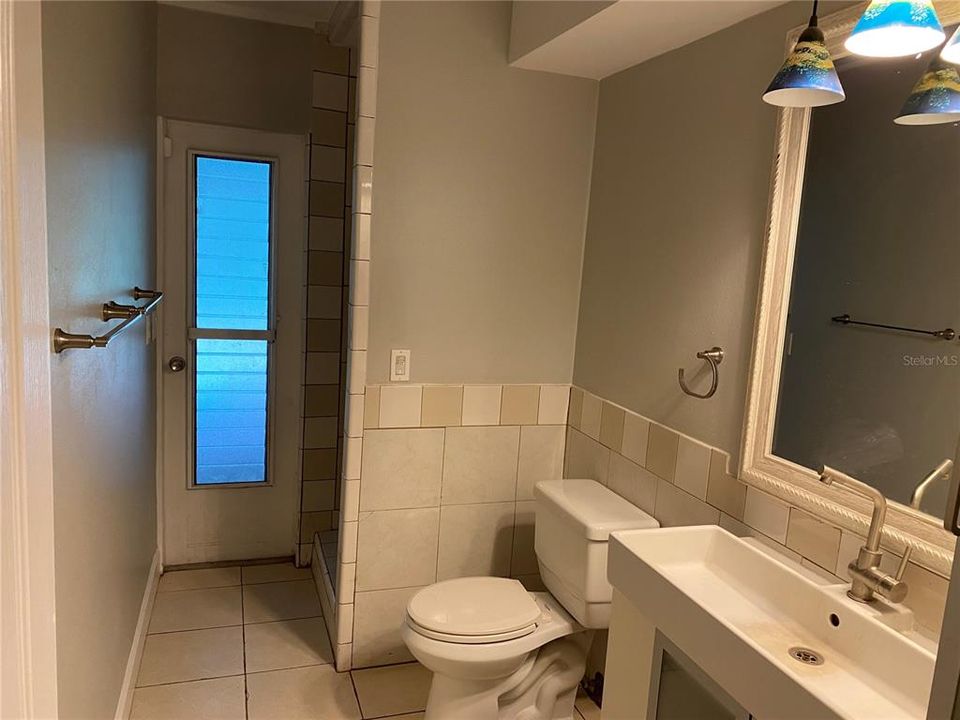 Second bath with door leading to pool area.