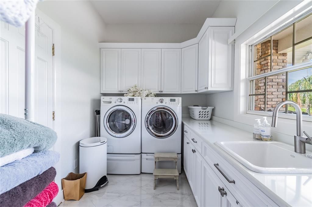 Spacious Laundry room, built in cabinets for storage and supplies. Washer & Dryer.