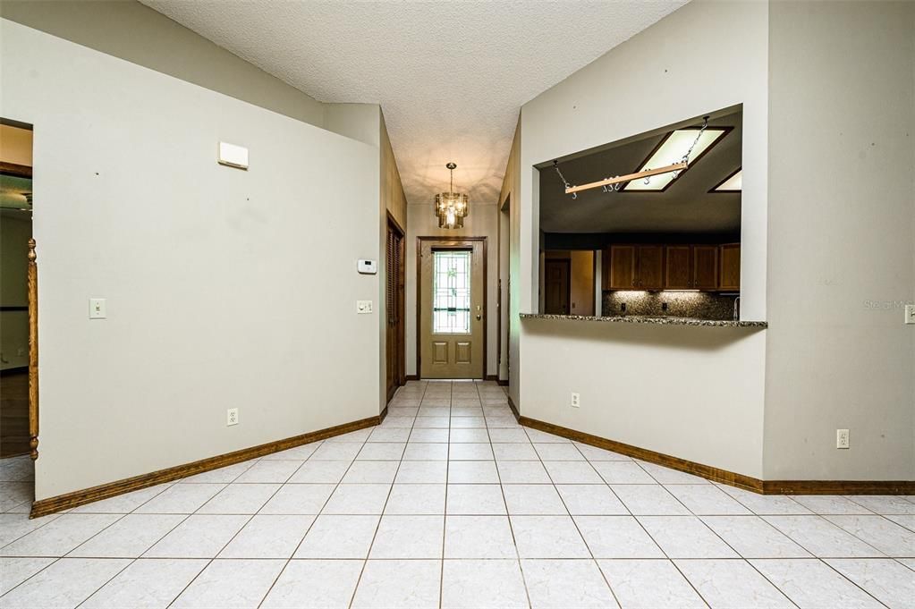 Front door with foyer and Breakfast bar at kitchen/living room