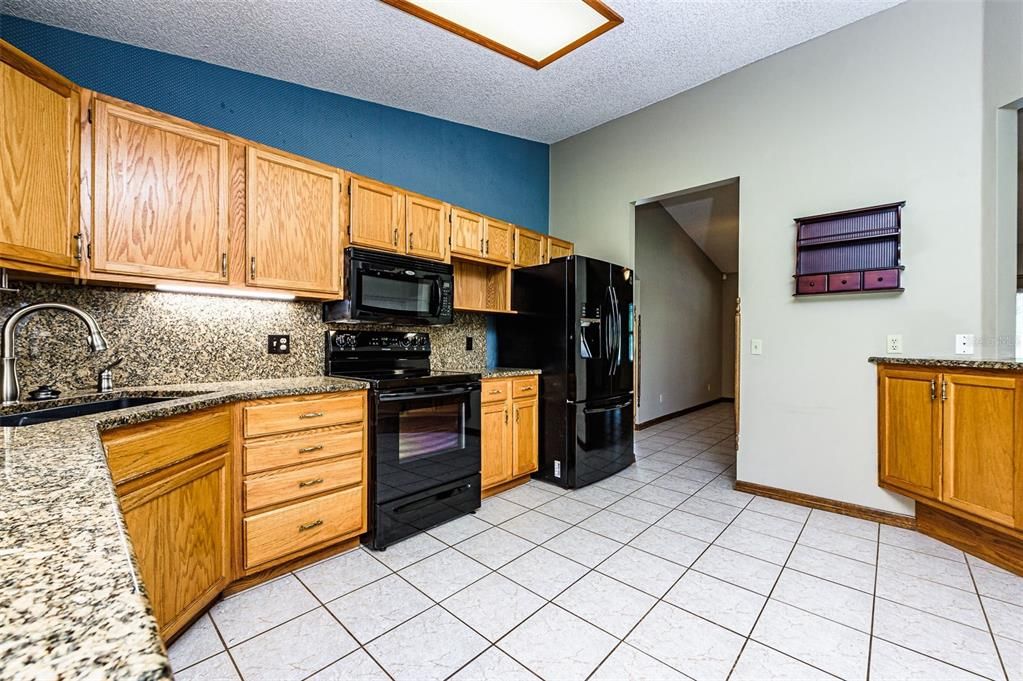 Look at all the counter space and wood cabinets.