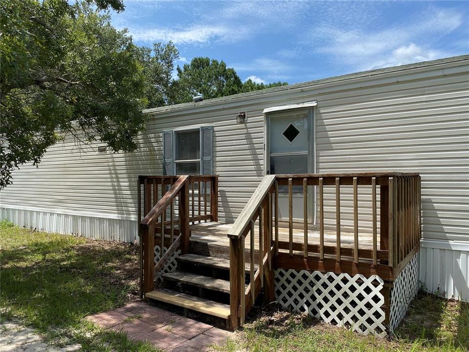 Entrance to home with deck/porch