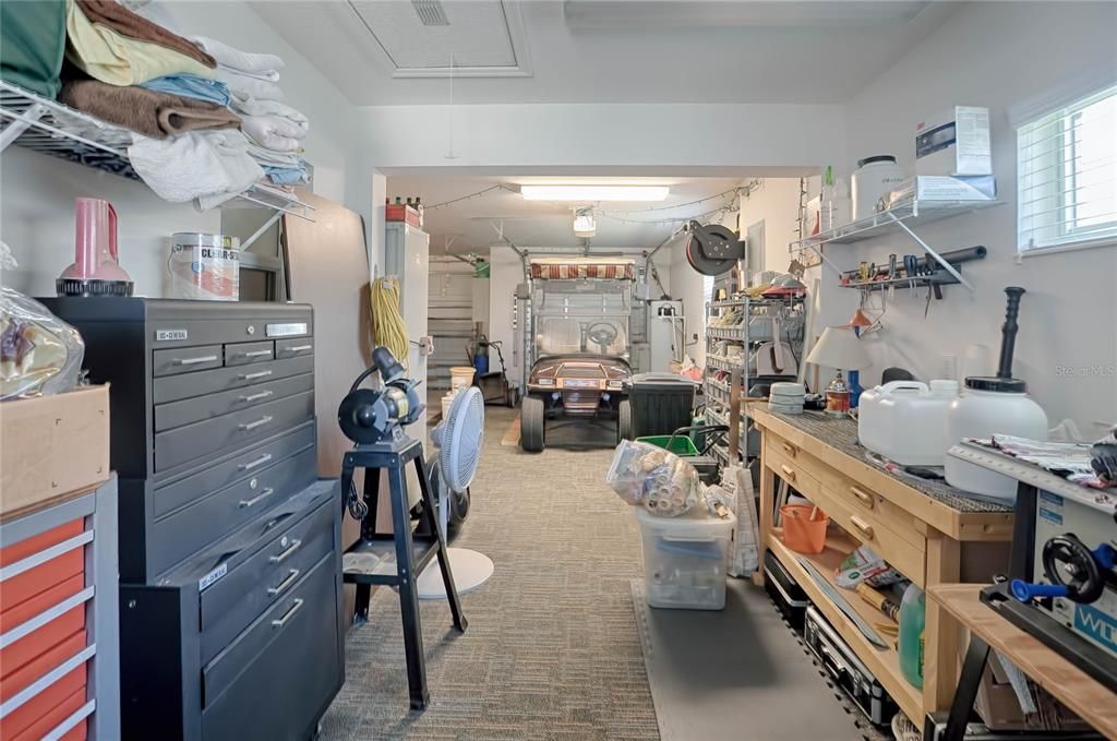 EXCUSE THE MESS -- WORKING ON CLEANING OUT WORKSHOP BUT WANTED TO SHOW THE EXTRA ROOM AVAILABLE!  YOU COULD FIT 3 GOLF CARTS IN THE GOLF CART GARAGE SIDE IF NEEDED!