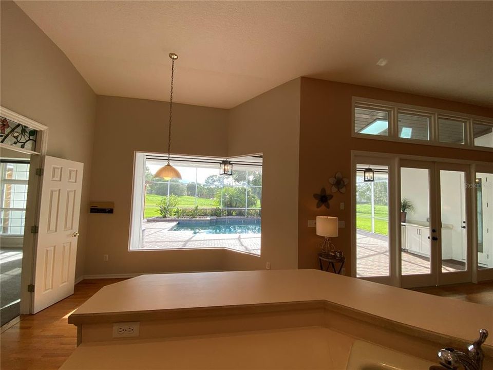 KITCHEN BREAKFAST BAR AND NOOK OVERLOOKS POOL LANAI AND DEN/MEDIA ROOM TO THE LEFT AND FAMILY ROOM TO THE RIGHT