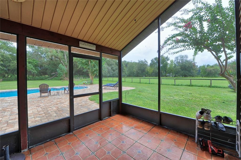 Screened back porch overlooking the pool