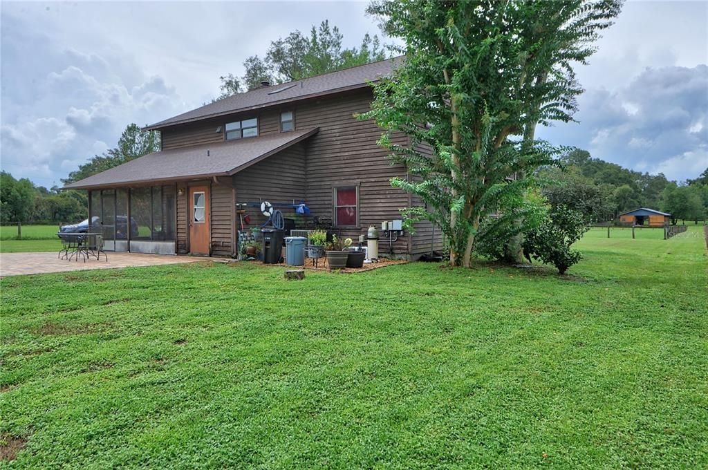 rear view of home with pool filter area