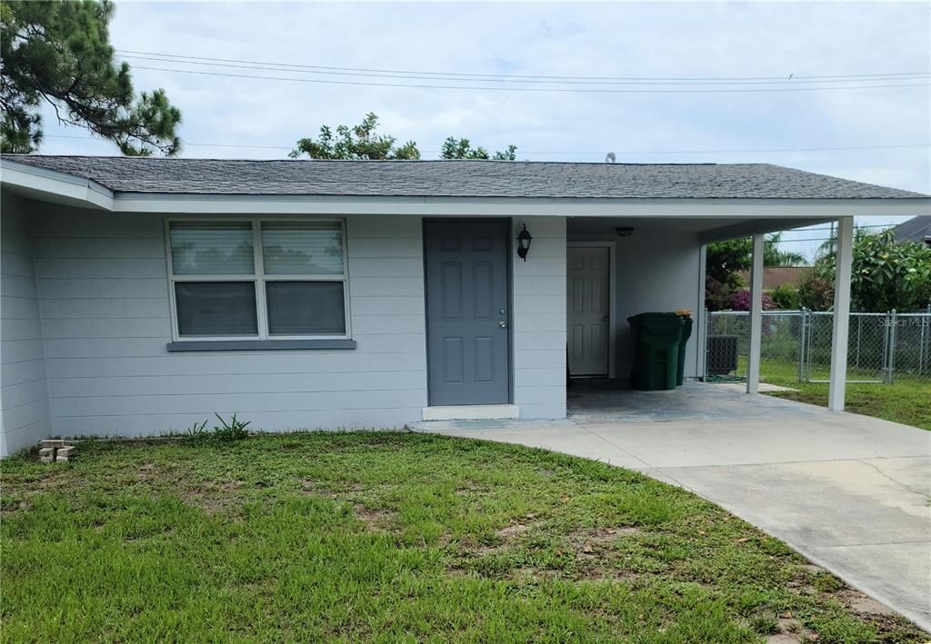 Front of house with carpet and storage