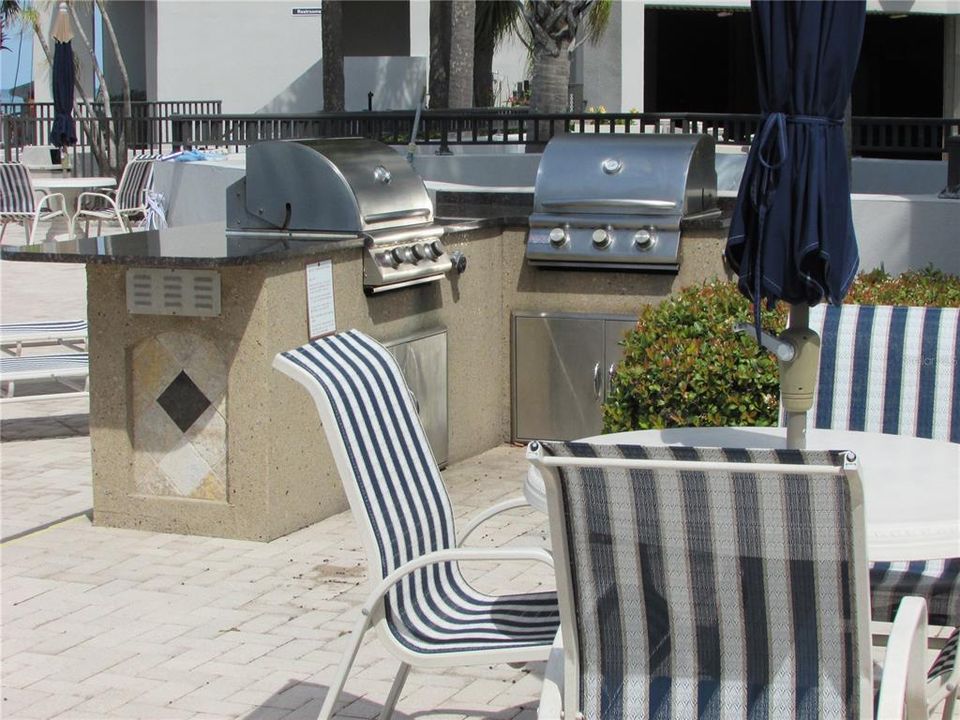 BBQ Grill and tables on the pool deck.