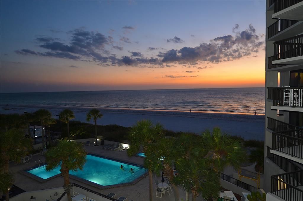 Sunset over the pool and beach. (This is not a view from the condo.)