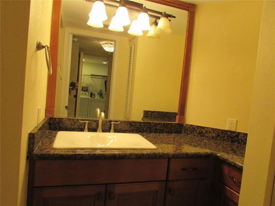 Guest Bathroom has granite and lots of storage.