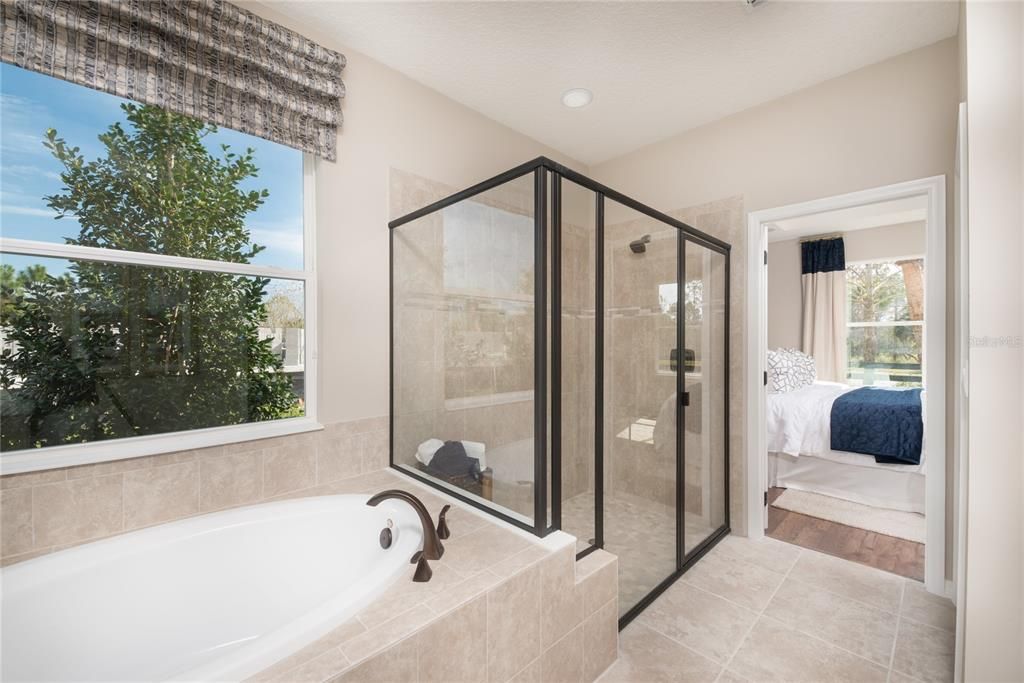REPRESENTATIVE PHOTO. Relax in this soaking tub or large shower that???s eye catching complementing the en-suite bathroom perfectly!