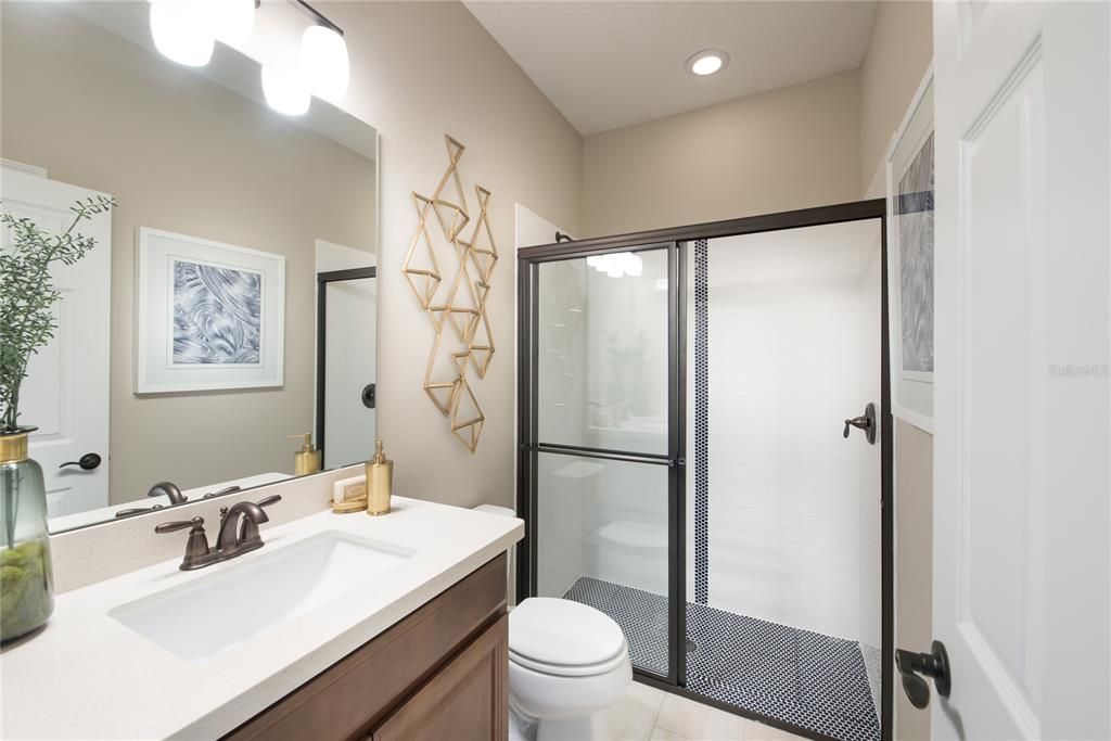 REPRESENTATIVE PHOTO. The secondary bathroom with a large walk-in shower, great storage vanity space and beautiful wall size mirror makes getting ready with ease in the morning.