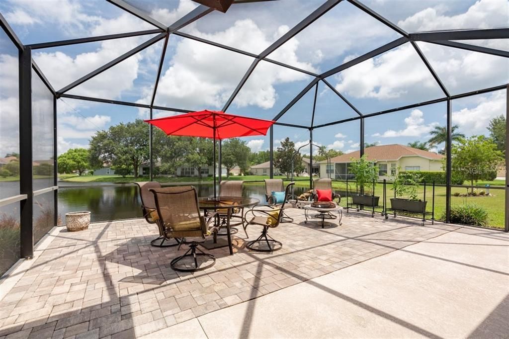 Screened in pavered lanai with pond views is the perfect place to start or end your day
