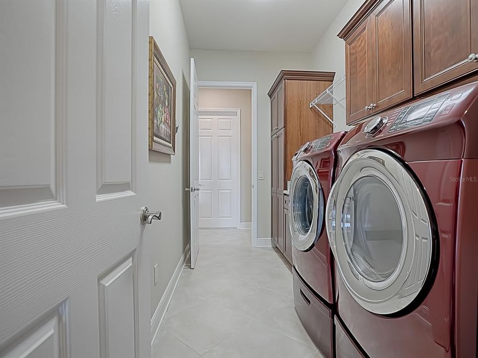 SPACIOUS LAUNDRY ROOM WITH BUILT-IN SINK AND LOTS OF EXTRA STORAGE SPACE!