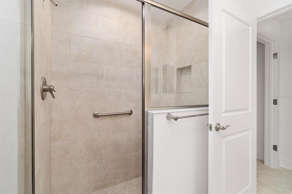 Front Guest Bathroom shower with shower bench and shampoo niche