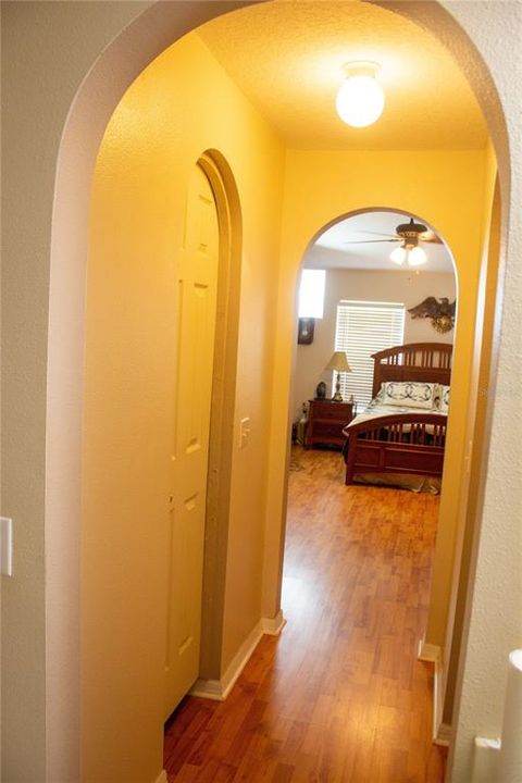 Showing one of two walk-in closets with arch top doors