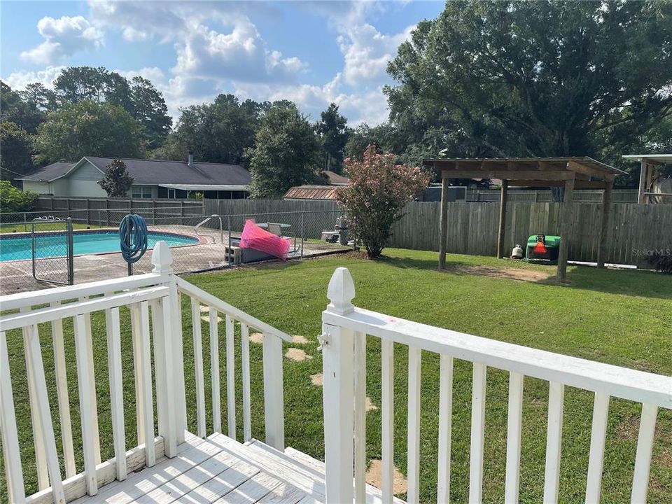 View of Backyard and pool from the Deck