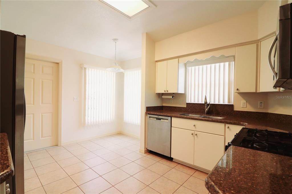 KITCHEN WITH BREAKFAST NOOK AND STONE COUNTERS