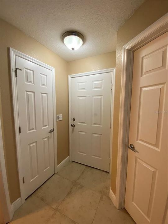 Front Foyer, Closet (L) and Laundry Room Door (R)