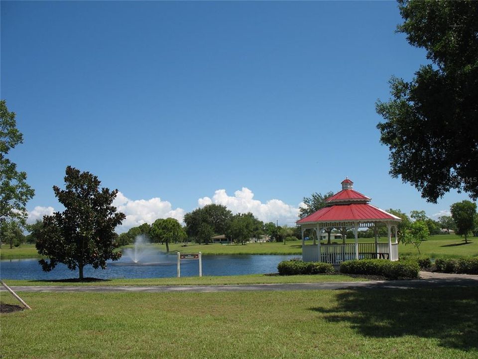 Gazebo and water fountain in pond