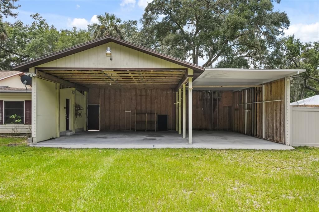 Fabulous 3 bay RV/Boat storage with rear access to sheds in left corner. Walk straight through the carport to access your work space and rear yard.