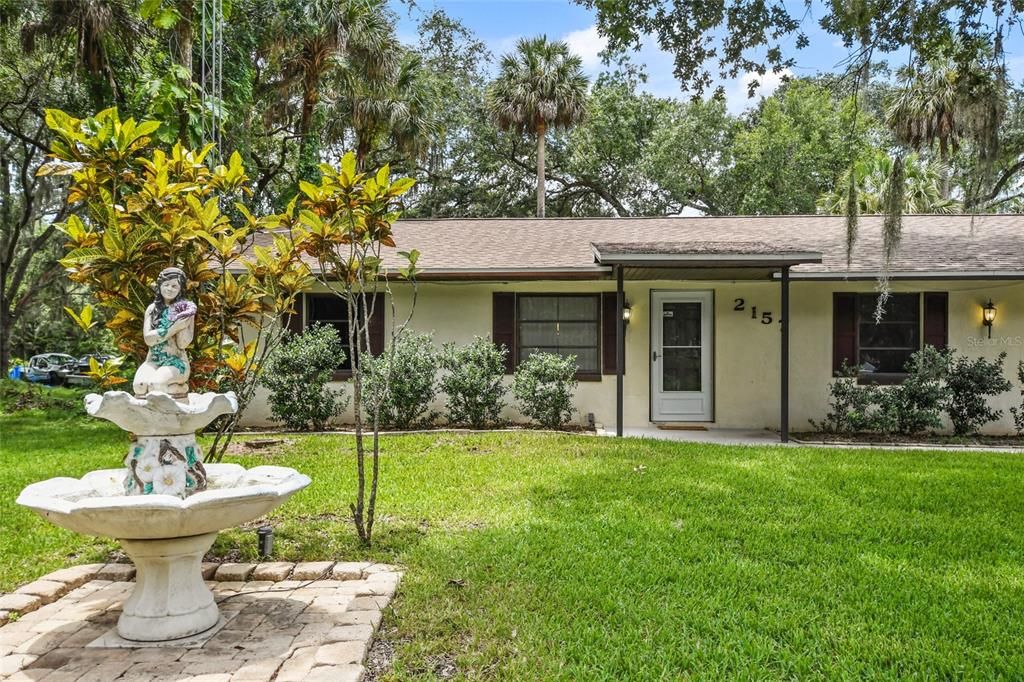 Stunning mature landscape and greenery create a peaceful retreat in this highly desired private county street in Oak Beach Colony.