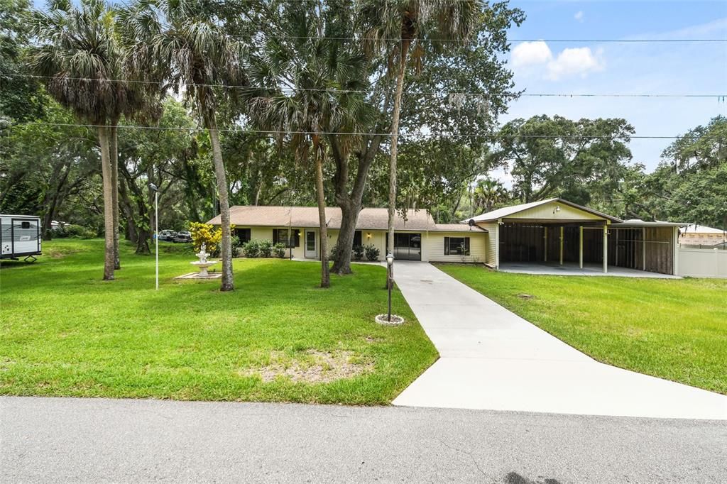 Welcome to an extraordinary opportunity. Terrific split bedroom floor plan supported by 3 HUGE RV/BOAT Carport and 2 other out buildings for storage. Expansive driveway holds many vehicles. Come make this Florida dream yours....... it won't last, don't hesitate come make it yours TODAY.