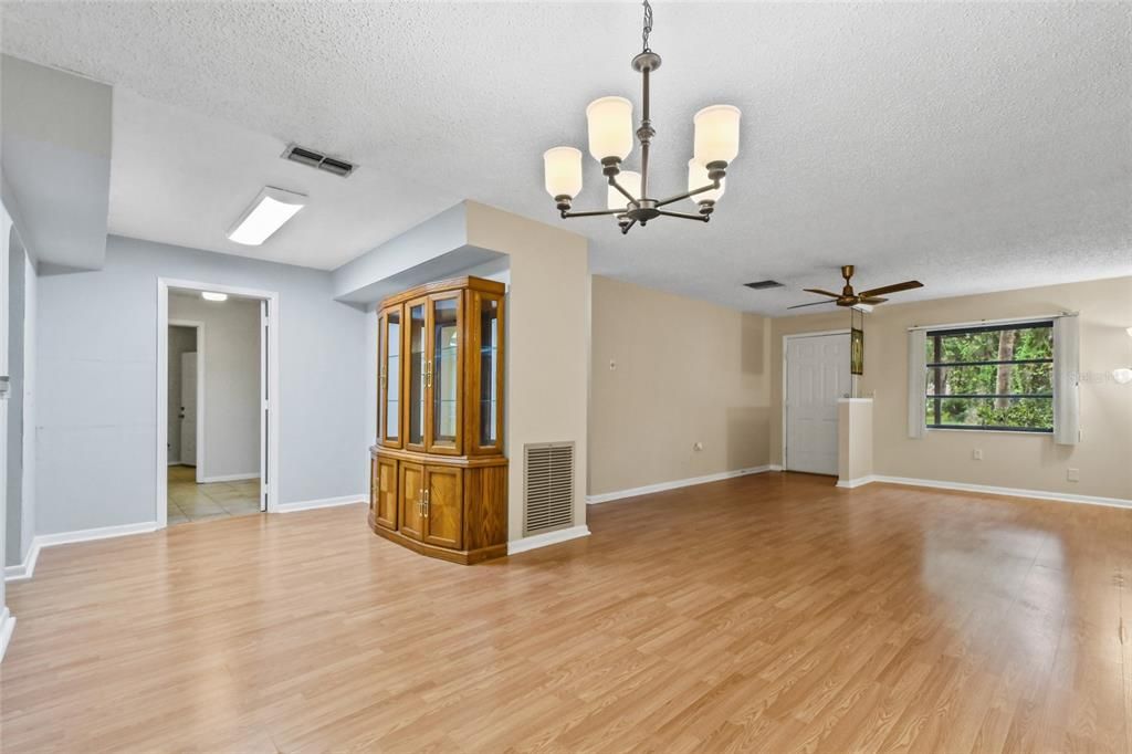 Upon entry you are welcomed into the great room which has a open floor plan featuring great room with ceiling fan and new dining room lighting to show off the laminate flooring throughout this common area.