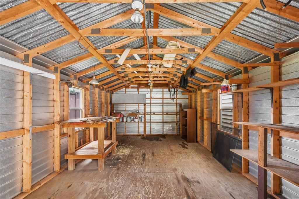 Totally equipped and ready for the carpenter, plumber, landscaper or do it yourself enthusiast! Lighting, electricity, work benches, shelving, rafters, with natural lighting and air circulation all topped with a metal roof to last for years.