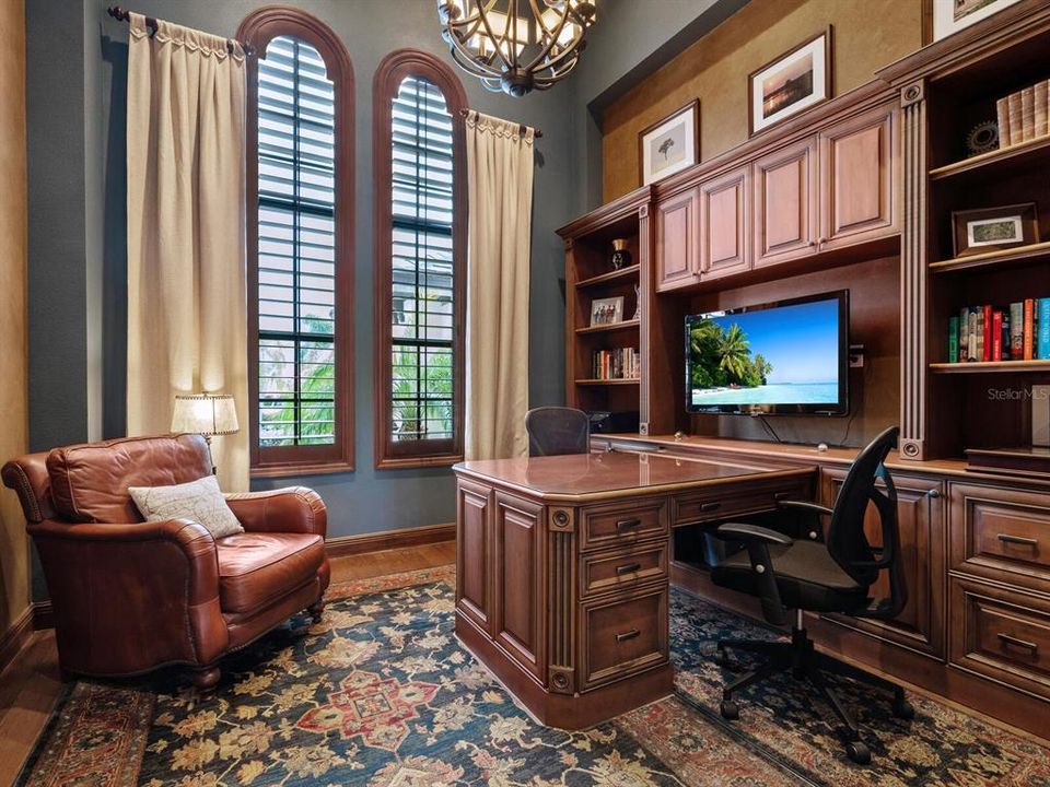 Spacious study with built-ins and plantation shutters.