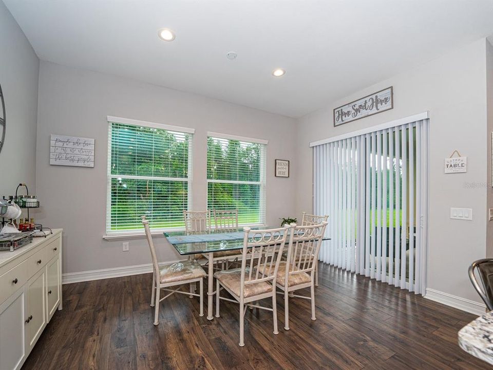 Breakfast nook with access to covered porch and windows to take in the serenity!