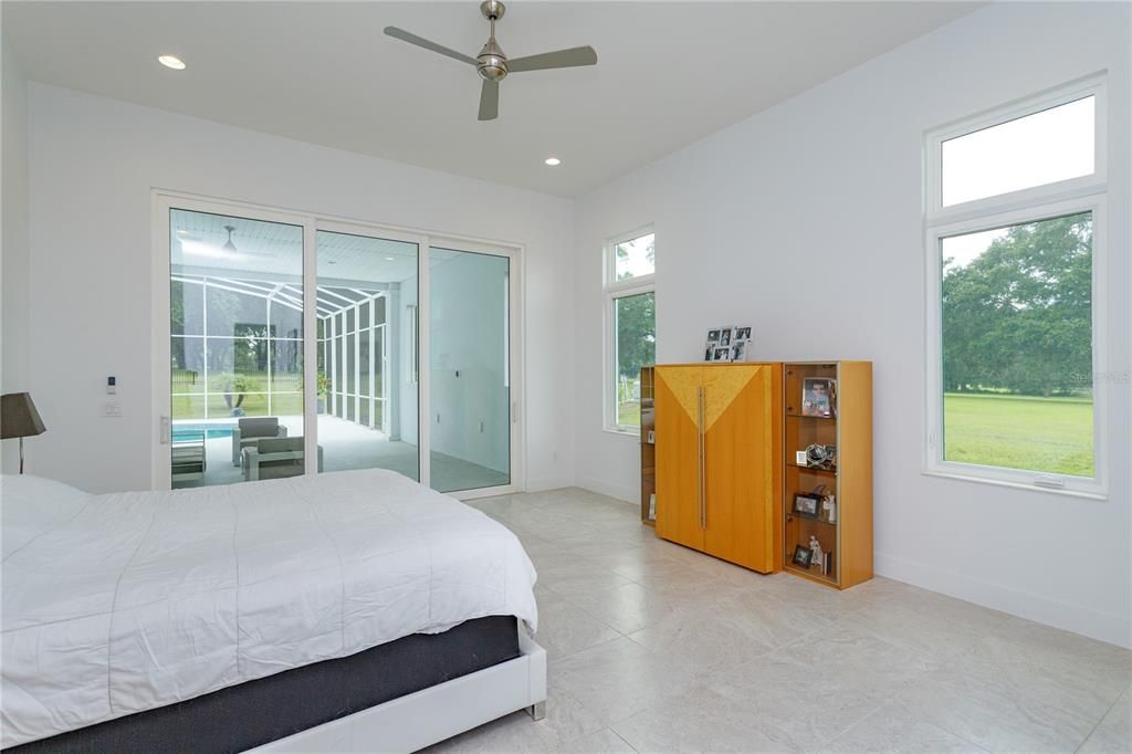 Spacious master bedroom with sliding doors to the pool/spa