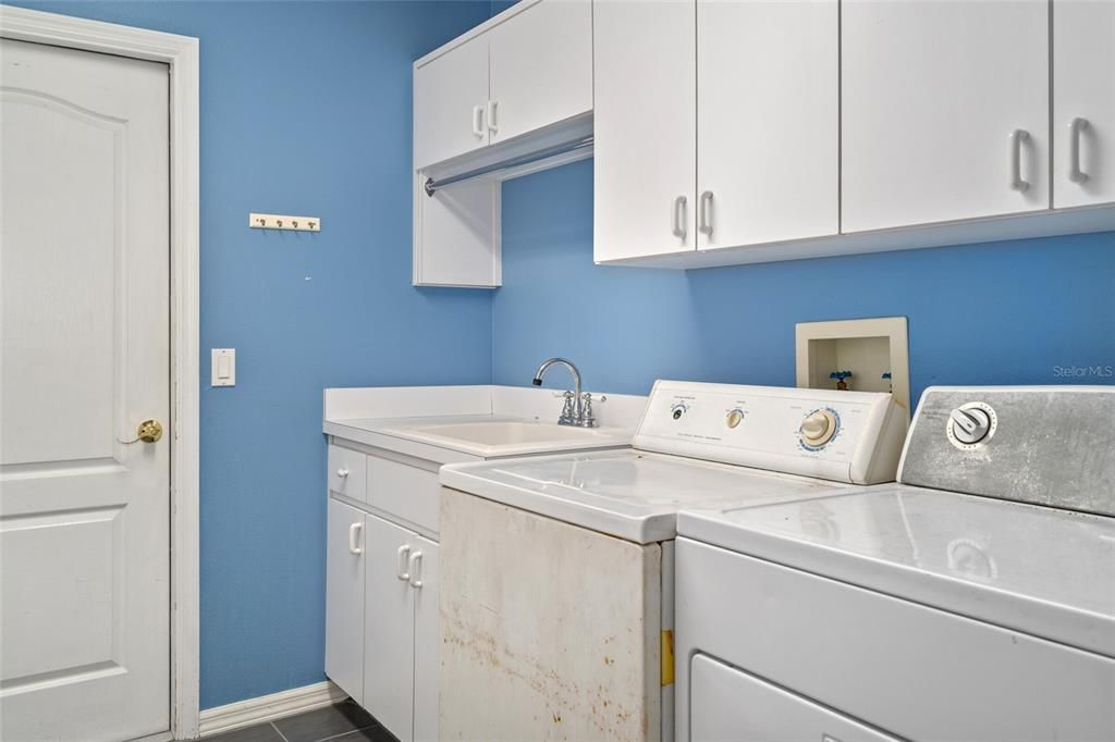 You'll love this laundry room! Lots of cabinets and laundry tub for convenience.  Bring your washer and dryer to complete the room.