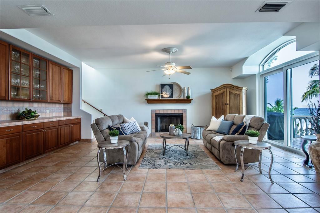 The main living level includes an expansive great room with dry bar with built in cabinetry, a wood burning fireplace, spacious kitchen, built in desk and the 3rd and 4th guest bedrooms with Jack-and-Jill bathroom as well as a half-bath for guests.